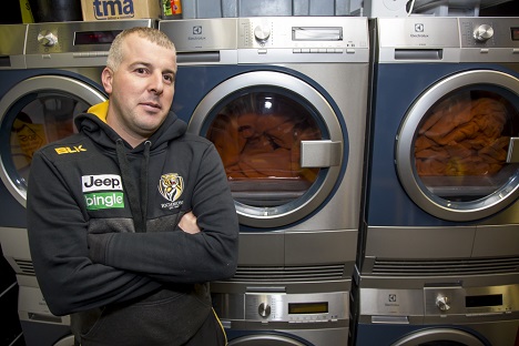 Footballer standing in front of washing machines